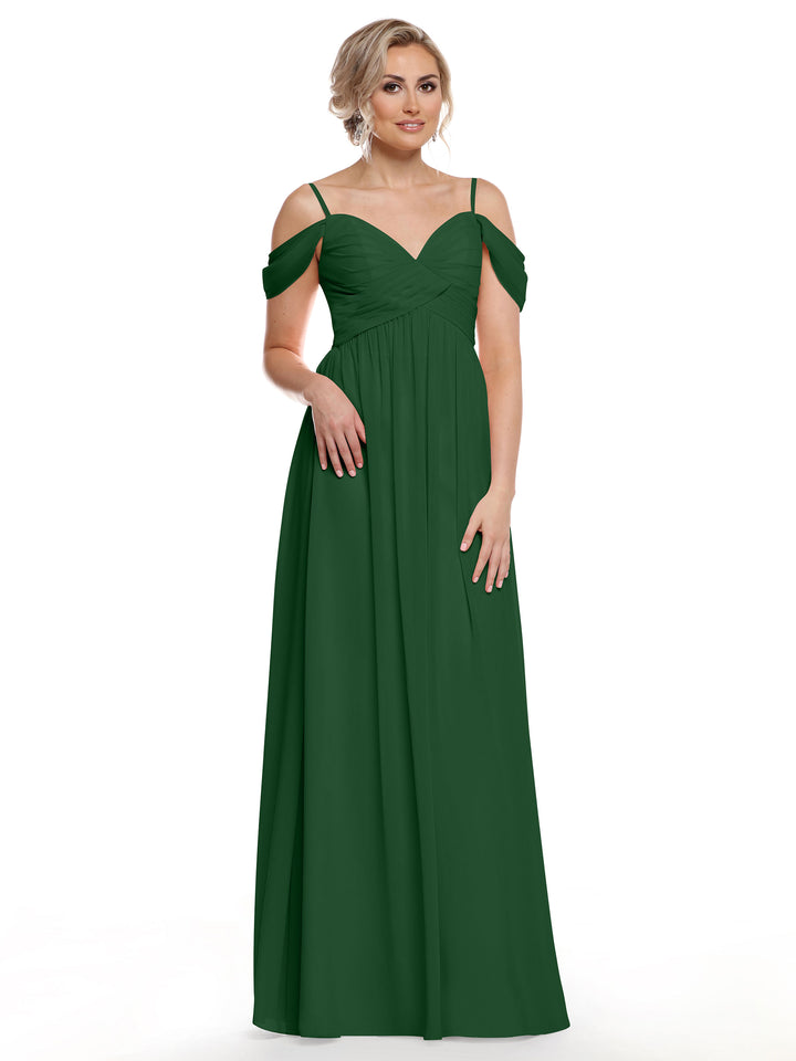 A woman models Avery Austin’s 80142, a dark green floor-length chiffon dress with spaghetti straps and off-the-shoulder sleeves, channeling boho chic style against a plain white background.