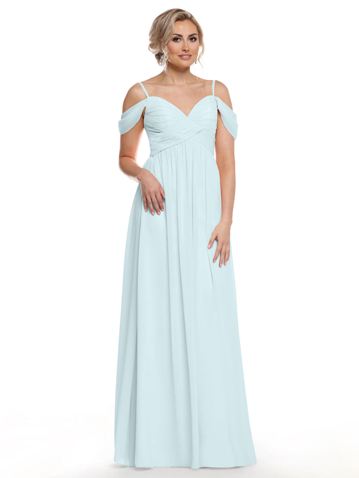 A woman with styled blonde hair stands against a white background, wearing the Avery Austin 80142 sky blue chiffon gown with floor-length, off-the-shoulder, and spaghetti straps, looking slightly off to the side.