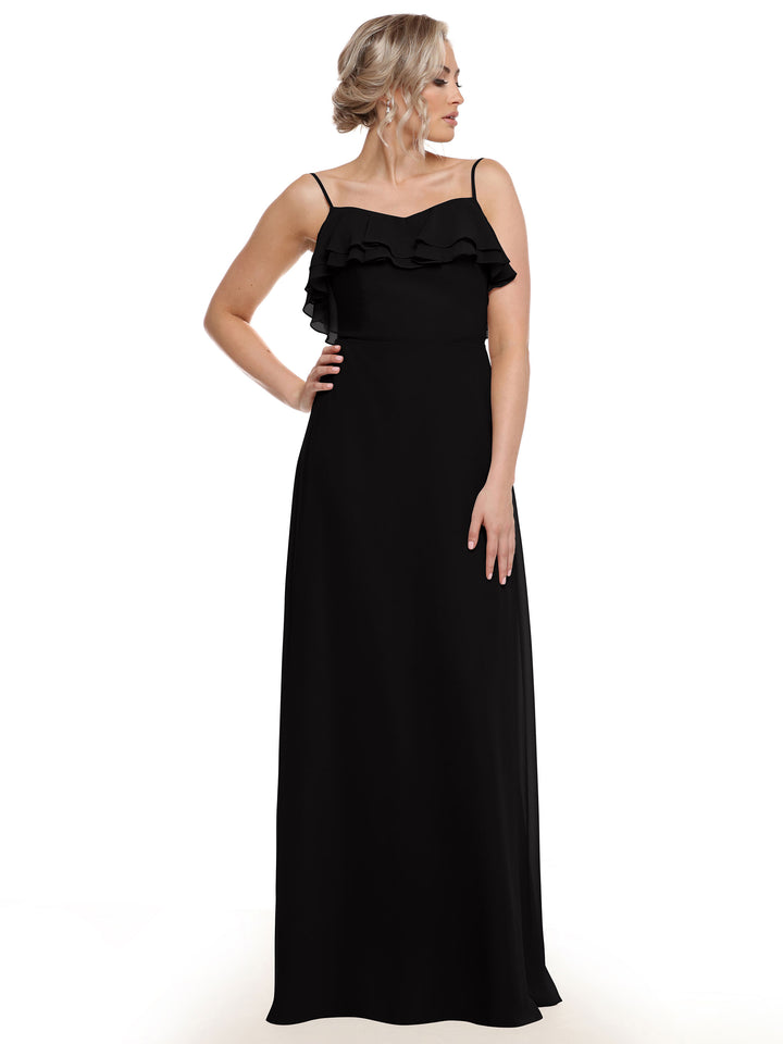 A woman poses elegantly against a white background in Avery Austin’s 80146—a long, sleeveless black chiffon A-line dress with thin straps and tiered chest ruffles—resting one hand on her hip and looking to the side.