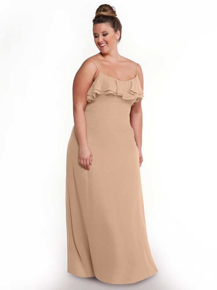 A woman with brown hair in a bun smiles while wearing Avery Austin&