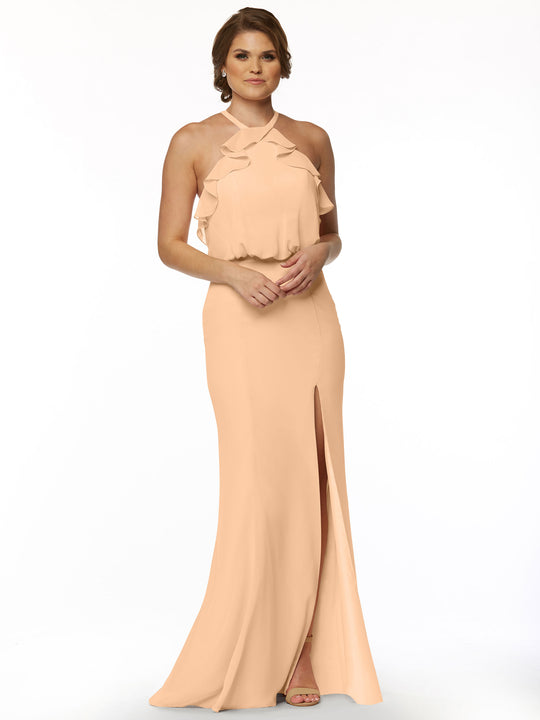 A woman models the Avery Austin TH-80147, a long peach chiffon dress with a ruffled halter top and side slit, against a plain white background.