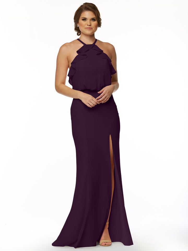 A woman in Avery Austin’s style 80147 poses against a white background, wearing a fitted chiffon dress with a ruffled halter neckline, front slit, short hair, and open-toe heels.