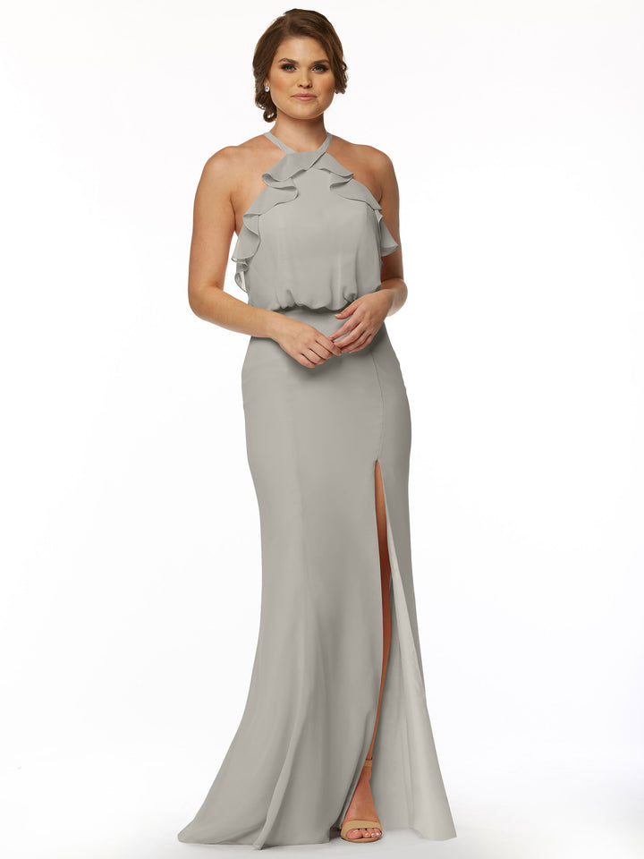 A woman models Avery Austin’s 80147, a sleeveless fitted chiffon dress in light gray with a ruffled halter top and thigh-high side slit, paired with nude heels against a plain white background.