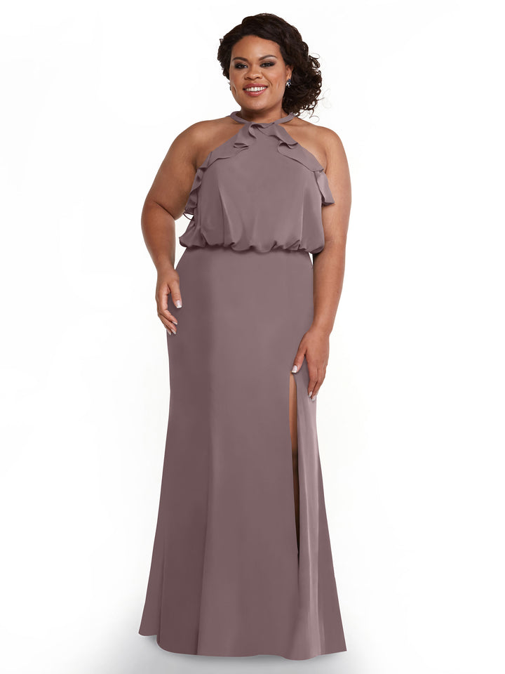 A woman smiles against a white background, wearing Avery Austin’s 80147: a sleeveless mauve chiffon fitted dress with a ruffled halter top and high side slit.
