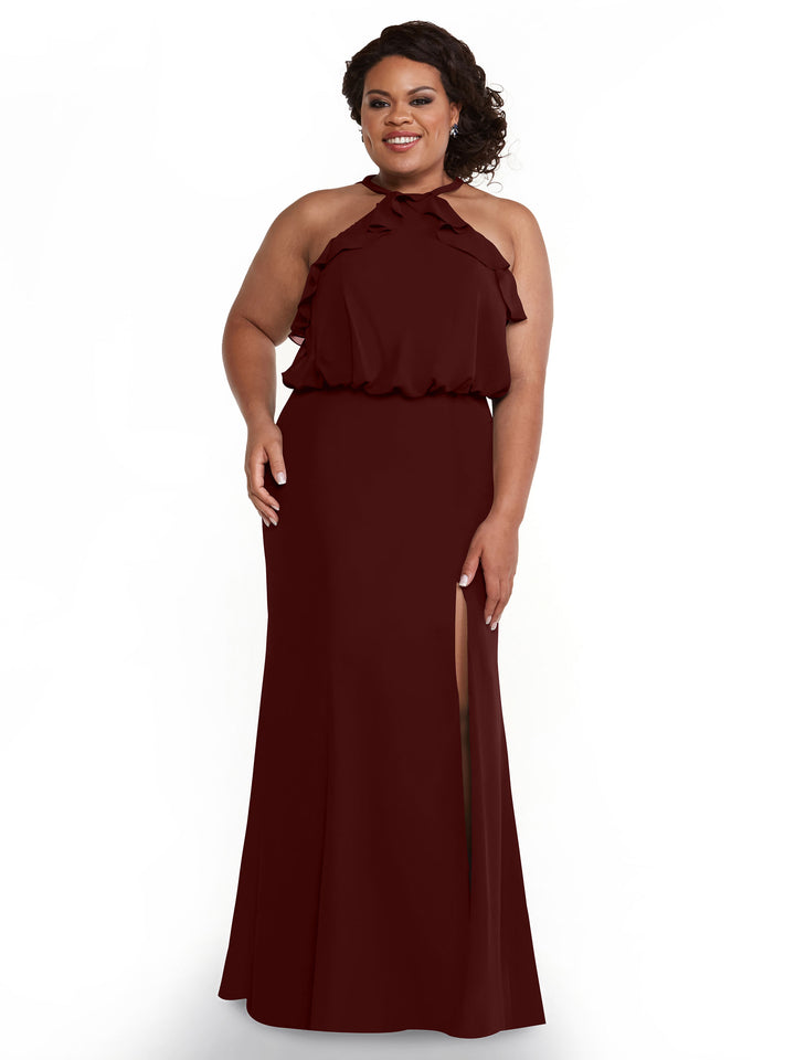 A woman models Avery Austin style 80147: a sleeveless, floor-length maroon chiffon dress with a high neckline, ruffle accents, and a thigh-high slit. She smiles against a plain white background with one hand at her side.