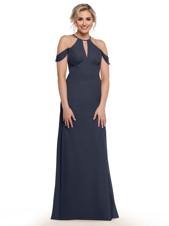 A woman wearing the Avery Austin 80148 dress—a floor-length, dark navy gown with a halter neckline, keyhole cutout, and chiffon cap sleeves—stands smiling against a white background.