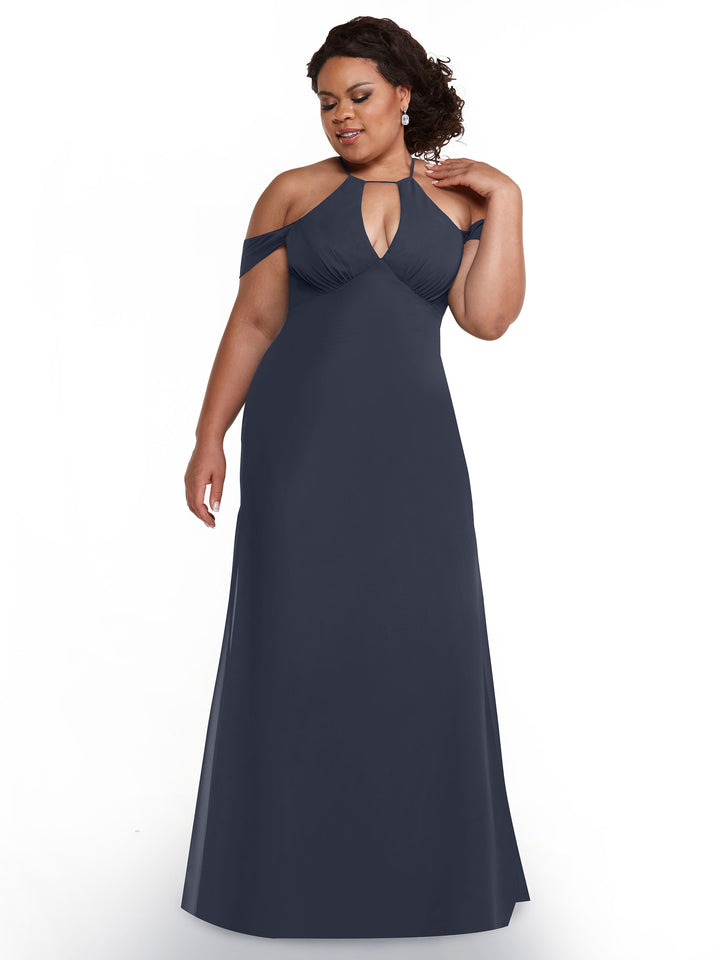 A woman poses against a white background in the Avery Austin TH-80148—a floor-length, dark navy off-the-shoulder chiffon gown with a keyhole neckline. Her hand touches her neck and her hair is styled in loose curls.