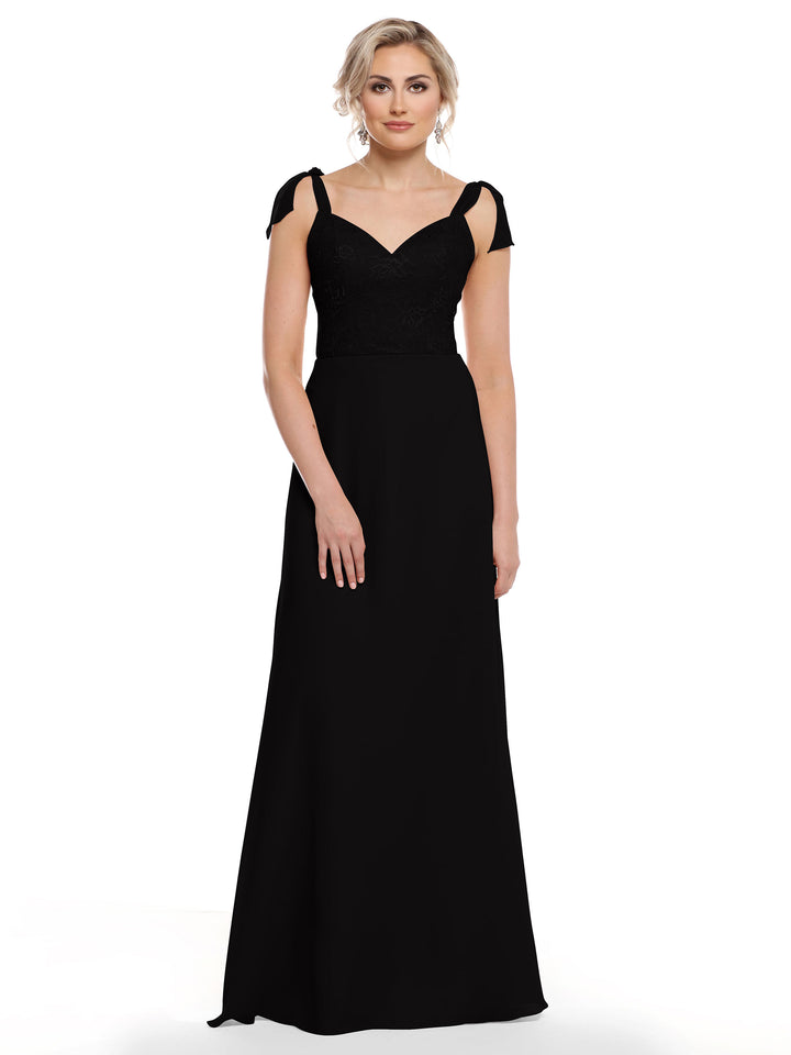 A woman in Avery Austin’s 80149 wears a long, elegant black chiffon dress with cap sleeves and a fitted floral lace bodice, facing forward against a plain white background.