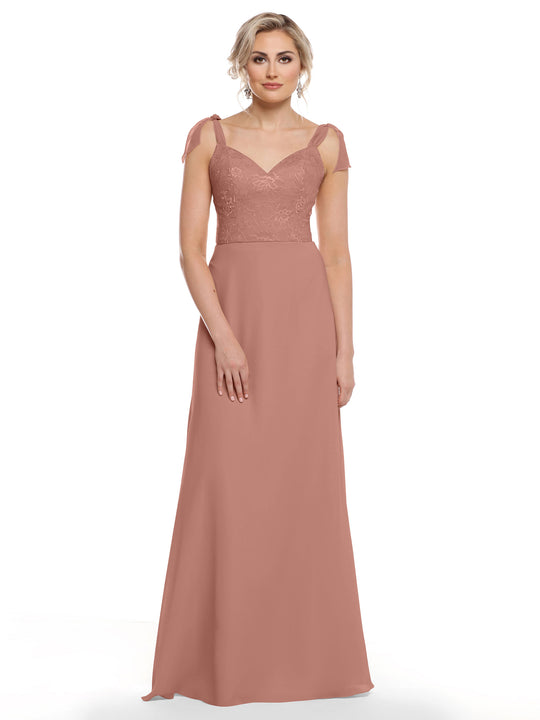A woman models the Avery Austin TH-80149 in Dusty Rose—a floor-length chiffon dress with a floral lace bodice, sweetheart neckline, and self-tie straps—posing against a white background.