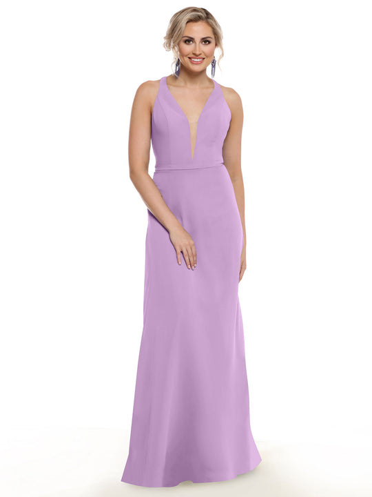 A woman with light hair styled up and dangling earrings stands against a white background wearing Avery Austin's 80150, a sleeveless lavender floor-length gown with a plunging neckline.