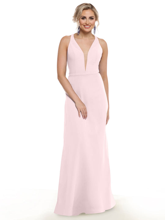 A woman wears Avery Austin's 80150: a light pink, sleeveless gown with a plunging neckline and fitted waist. She has her blonde hair in an updo, blue drop earrings, and smiles at the camera against a plain white background.