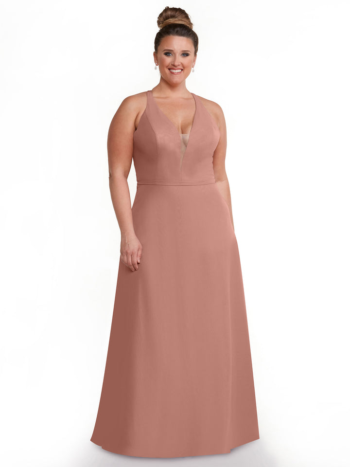 A woman in the Avery Austin TH-80150, a striking pink dress with geometric cut-outs.