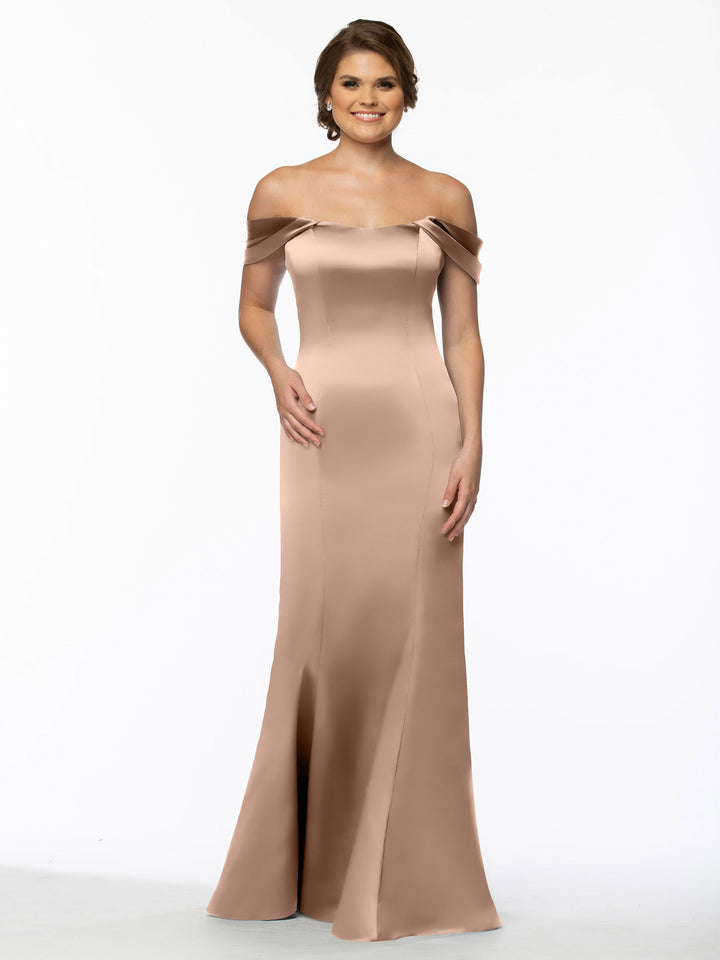 A woman stands smiling against a plain white background, wearing Avery Austin&