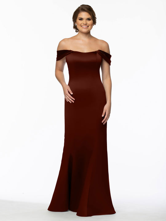 A woman models the Avery Austin 80151, a floor-length, off-the-shoulder dress with convertible straps. The fitted gown hugs her bodice and hips before gently flaring at the bottom, showcased against a plain white background.