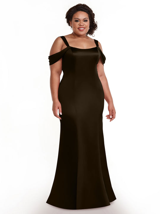 A woman with dark, curly hair styled up smiles against a white background, wearing the Avery Austin TH-80151—a long, chocolate off-the-shoulder dress with a fitted bodice and flared hem.