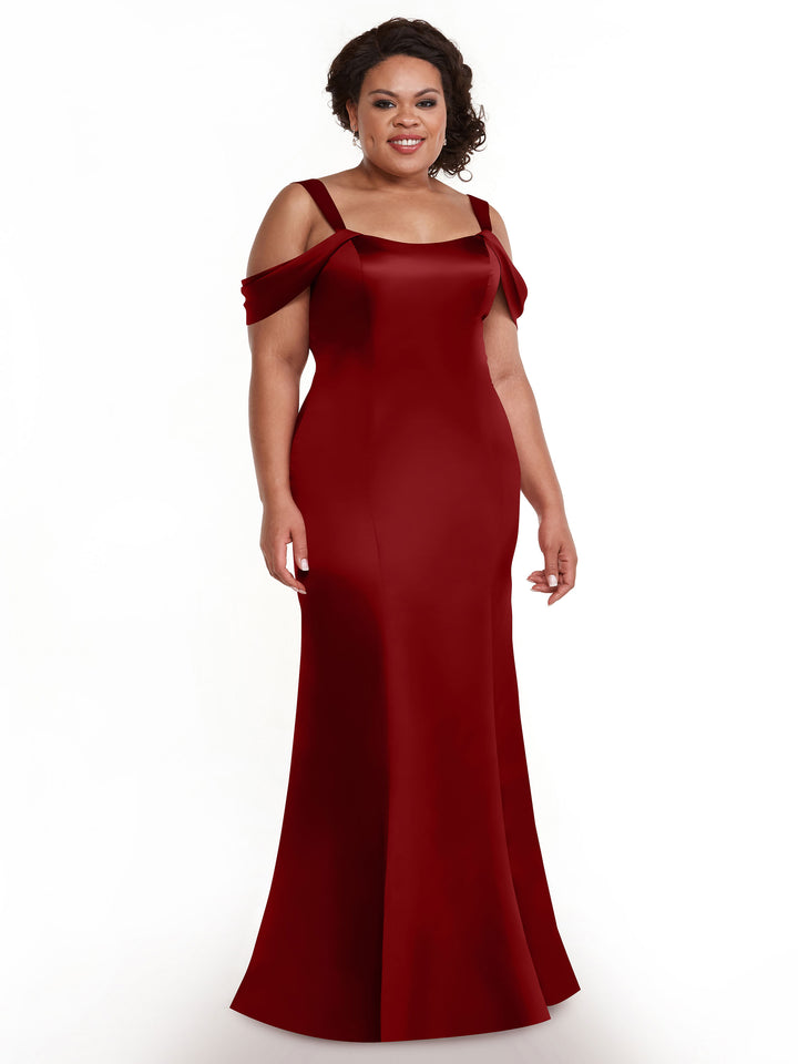 A woman smiles against a white background wearing the Avery Austin TH-80151 dress, a claret floor-length, off-the-shoulder gown with a fitted bodice.