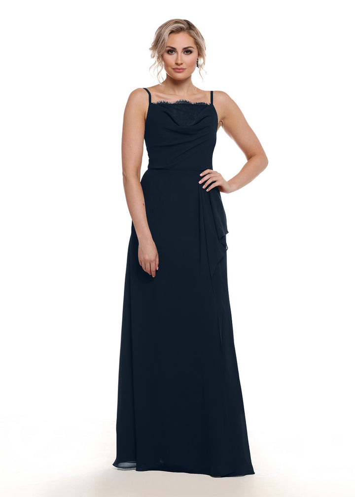 A woman with short, wavy blonde hair and a neutral expression poses against a white background wearing Avery Austin&