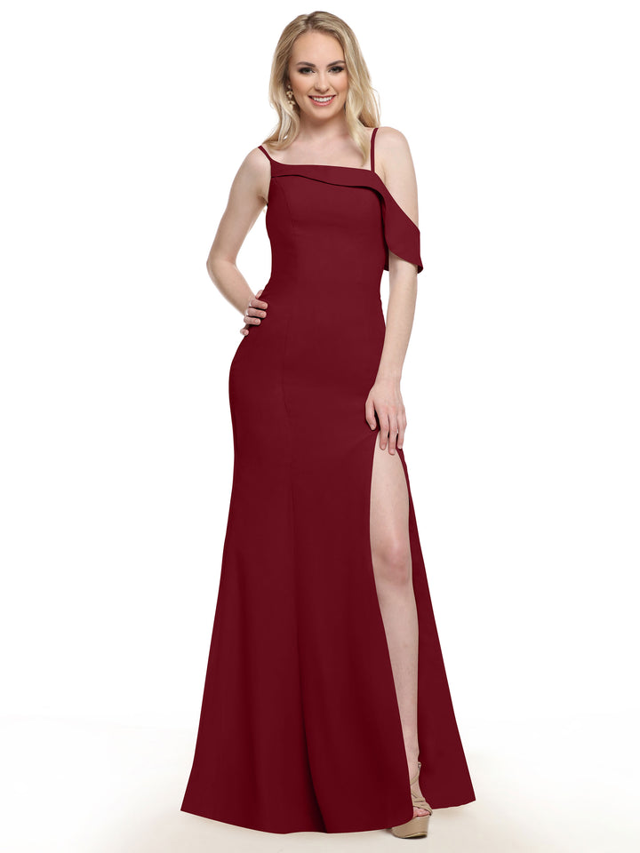 A woman wearing Avery Austin style 80153, a sleeveless floor-length burgundy chiffon bridesmaid dress with a thigh-high slit, smiles with one hand on her hip against a plain white background.