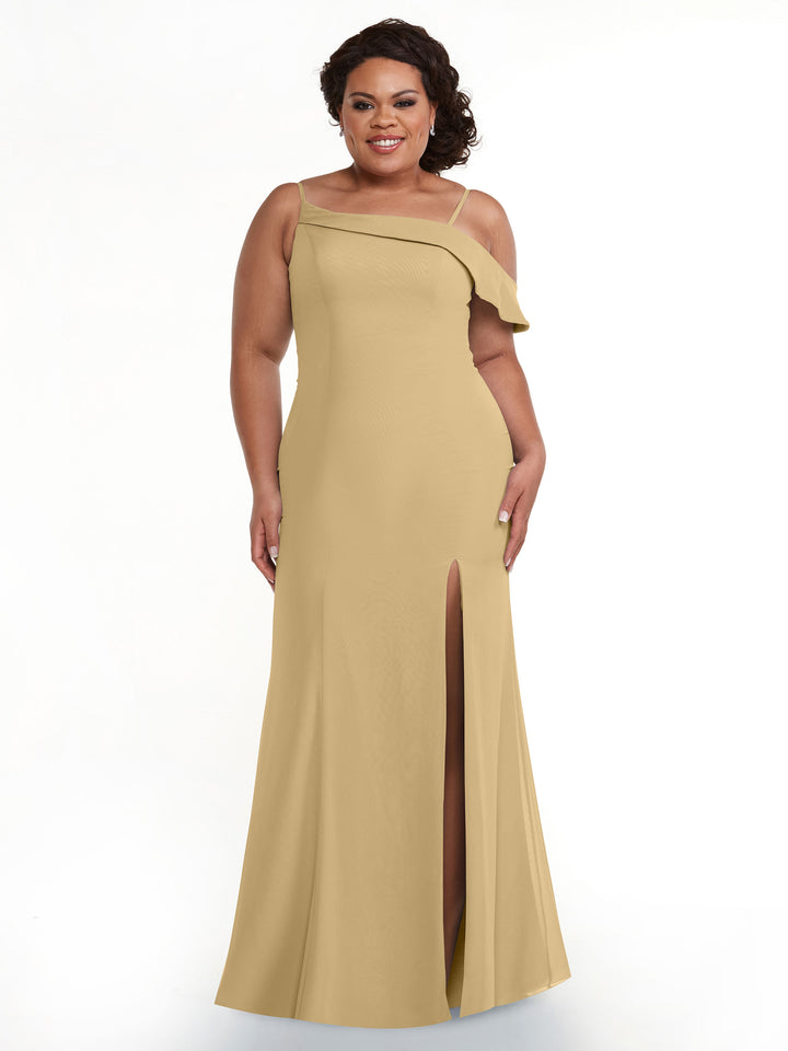 A woman models Avery Austin style 80153, a long light gold one-sleeve bridesmaid dress with a thigh-high slit, smiling against a plain white background.