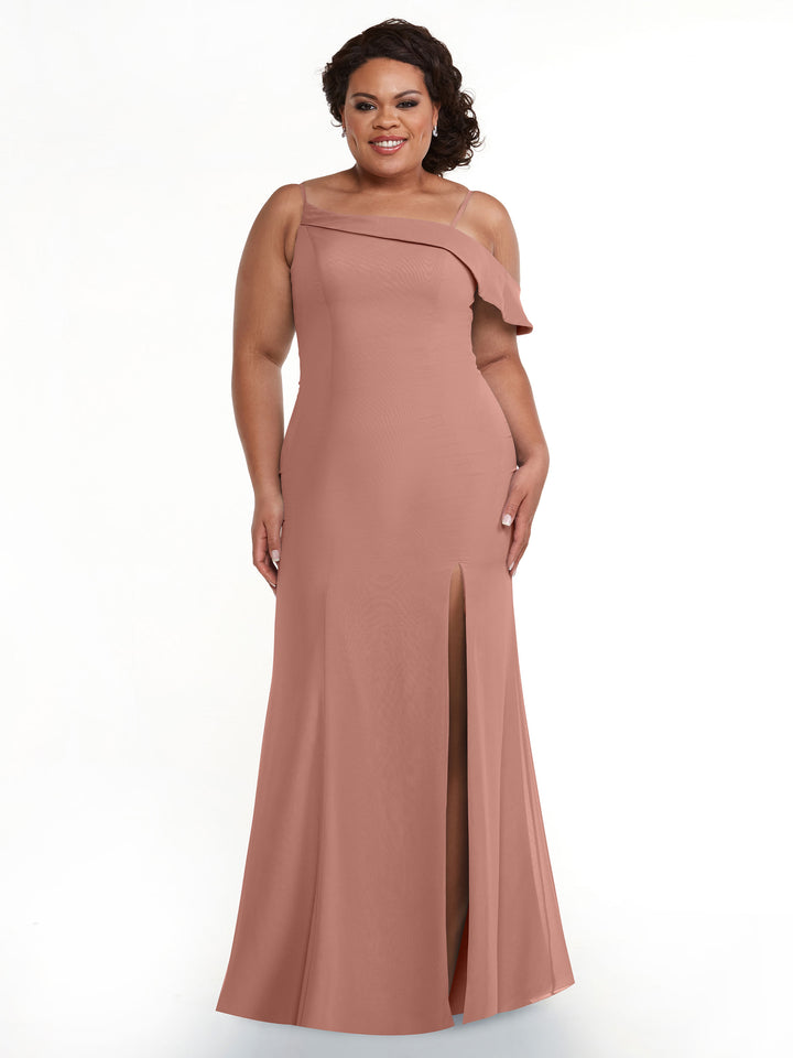 A woman models Avery Austin’s 80153, a dusty rose sleeveless gown with an asymmetrical neckline and high slit, smiling against a plain white background.