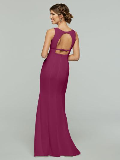 A woman faces away in Avery Austin’s 80155—a long, sleeveless magenta chiffon fit-and-flare dress with an open keyhole back and delicate bow. Her hair is styled up against a plain light gray background.
