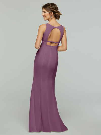 A woman models Avery Austin’s 80155: a long, sleeveless mauve chiffon dress with a keyhole back and open cutout, standing against a plain light gray background and looking over her shoulder.