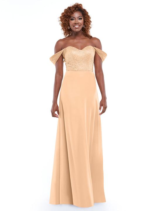 A woman wears the Avery Austin 80164 gold off-the-shoulder dress with a lace bodice and chiffon skirt, smiling against a plain white background.