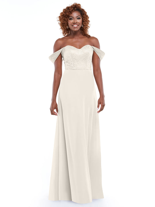 A smiling woman with curly hair models Avery Austin’s 80164, an off-the-shoulder dress with a lace bodice and flowing chiffon skirt, posed against a plain white background.