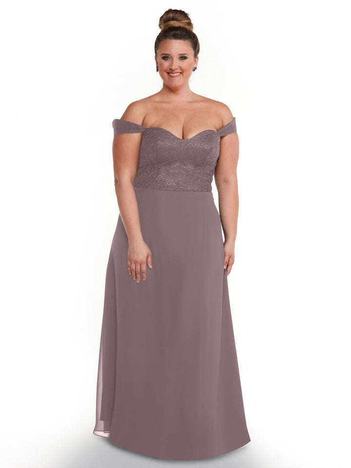 A woman with a bun wears Avery Austin style 80164, an off-the-shoulder mauve dress with a lace bodice and flowing chiffon skirt, standing against a white background and smiling softly.