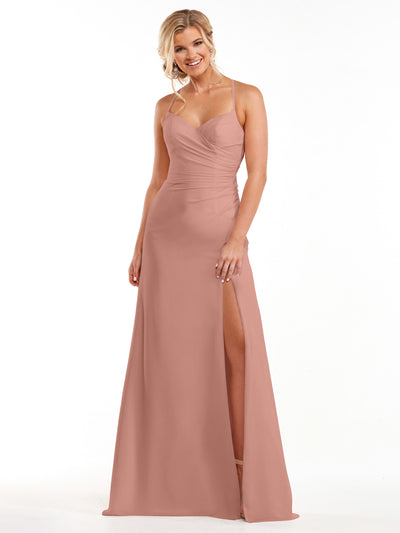 A woman smiles in the Avery Austin 80167, a dusty rose floor-length chiffon dress with spaghetti straps, fitted bodice, and thigh-high slit, standing against a plain white background.