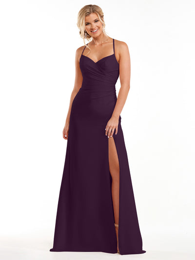 A woman in the Avery Austin 80167, an eggplant sleeveless floor-length chiffon dress with a sweetheart neckline and thigh-high slit, stands smiling against a plain white background.