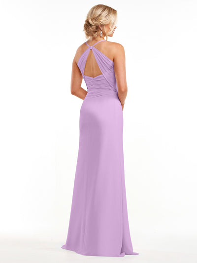 A woman with blonde hair in a low updo wears the Avery Austin 80167, a floor-length lavender chiffon dress with a ruched bodice, keyhole back, and delicate spaghetti straps as she stands facing away on a white background.