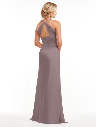 A woman wearing Avery Austin's 80167, a mauve floor-length chiffon gown with a ruched fitted bodice and halter neckline creating an upper back keyhole, stands with her back to the camera.