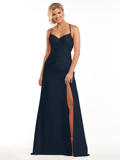 A woman smiles against a white background wearing Avery Austin style 80167, a midnight floor-length chiffon dress with spaghetti straps, a sweetheart neckline, and a high slit.