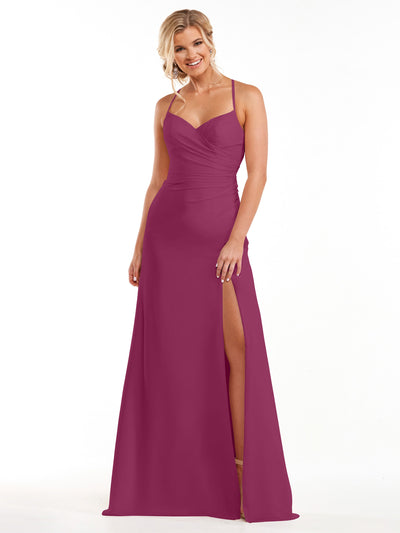 A woman models Avery Austin’s 80167, a sleeveless, floor-length plum chiffon dress with a sweetheart neckline, spaghetti straps, ruched bodice, and high slit. She stands smiling against a white background.