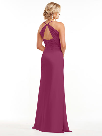 A woman in the Avery Austin 80167 floor-length magenta chiffon dress with a halter neckline and open back stands facing away. Her blonde hair is in a low updo, and she wears dangling earrings against a white background.