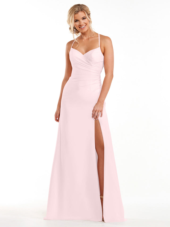A woman wears the Avery Austin TH-80167 bridesmaid dress in Rose Petal, featuring a floor-length chiffon skirt, spaghetti straps, sweetheart neckline, ruched bodice, and high thigh slit, standing and smiling against a white background.
