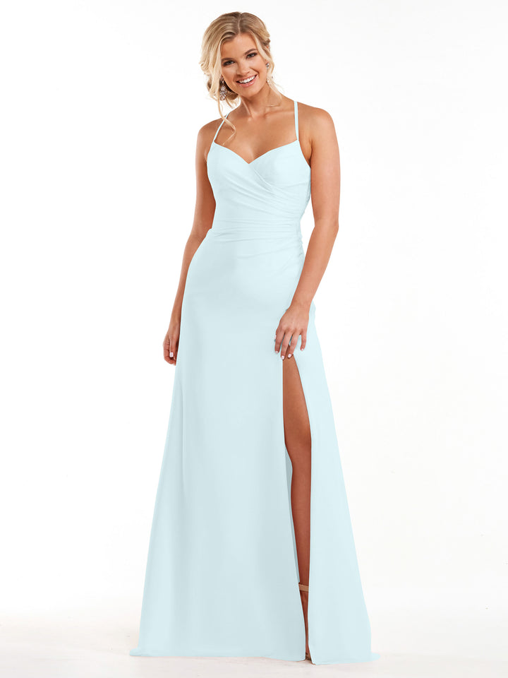 A woman smiles in the Avery Austin 80167 dress—a sky blue, floor-length chiffon gown with spaghetti straps and a thigh-high slit—standing against a white background.