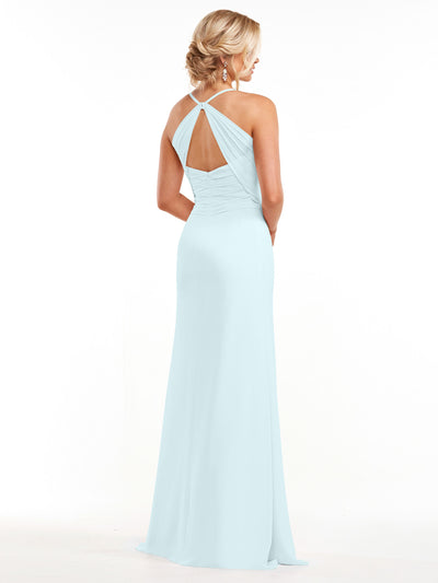 A woman models Avery Austin's 80167: a pale blue, floor-length chiffon dress with a halter neckline and keyhole back, her hair in a low, elegant updo as she stands facing away.