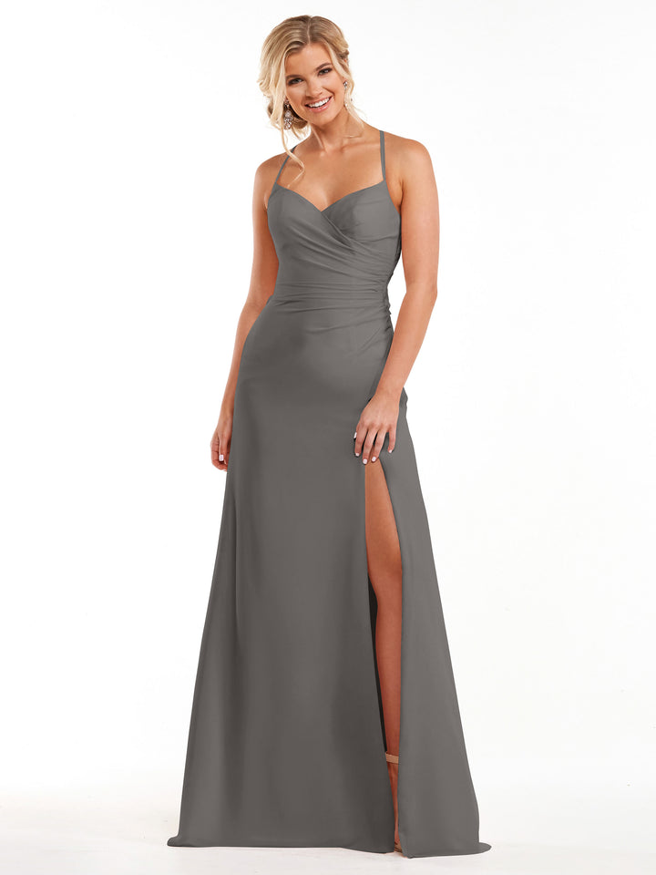 A woman smiles while wearing Avery Austin’s 80167, a steel gray chiffon dress with spaghetti straps, a sweetheart neckline, and a high slit, standing against a plain white background.