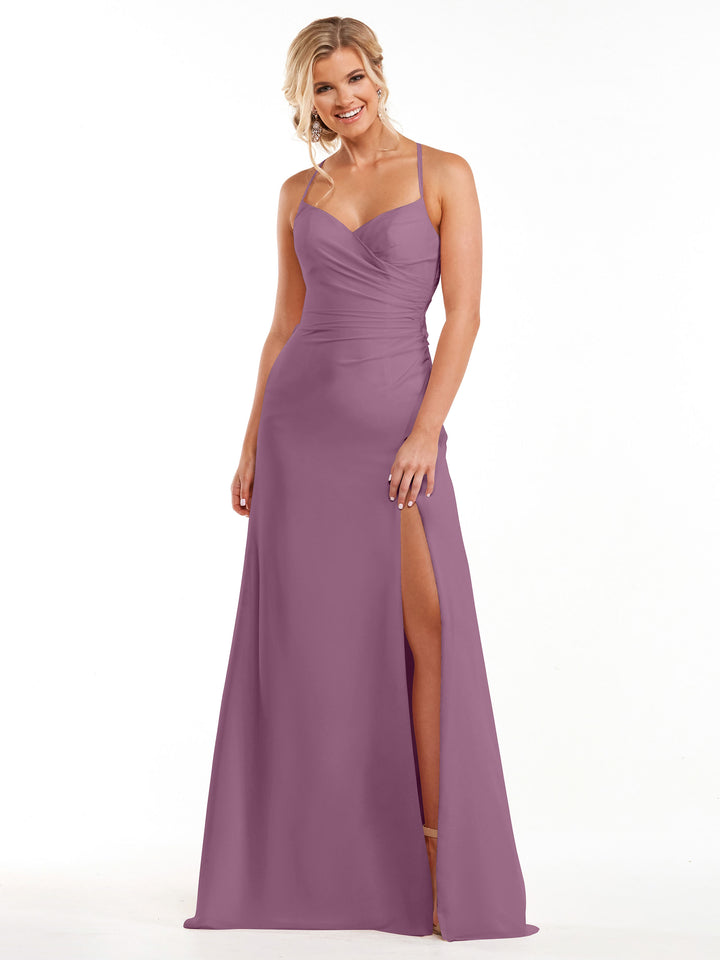 A woman smiles in Avery Austin style 80167, a mauve chiffon bridesmaid dress with spaghetti straps, sweetheart neckline, ruched bodice, high slit, and floor-length hem against a white background.