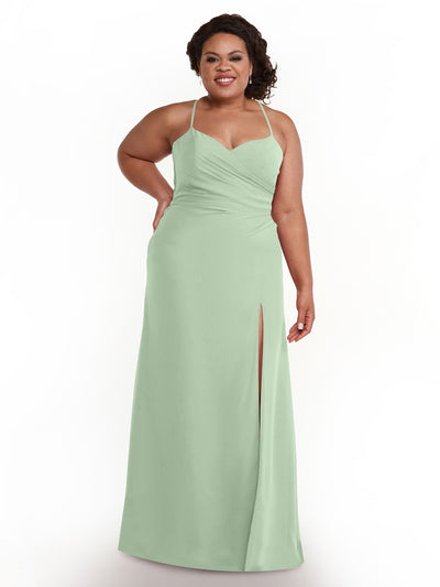 A woman wears Avery Austin dress 80167, a light green chiffon gown with spaghetti straps, a sweetheart neckline, and a thigh-high slit, smiling with one hand on her hip against a plain white background.