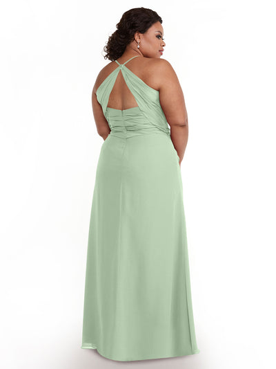 A woman models Avery Austin dress 80167, a long light green chiffon gown with a keyhole back, standing against a plain white background and looking over her shoulder.