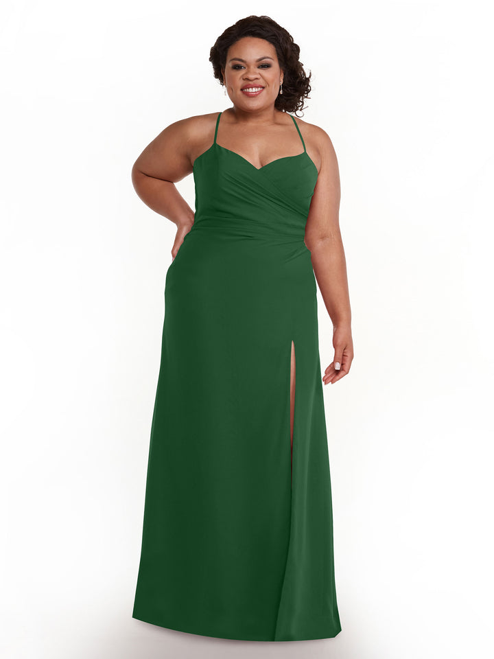 A woman smiles in the Avery Austin 80167, a hunter green sleeveless chiffon dress with spaghetti straps, a sweetheart neckline, ruched bodice, thigh-high slit, and floor-length skirt, standing against a plain white background.