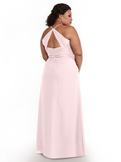 A woman with dark hair styled back wears the Avery Austin 80167 light pink chiffon dress, featuring crisscross halter straps and a keyhole back, while standing against a plain white background.