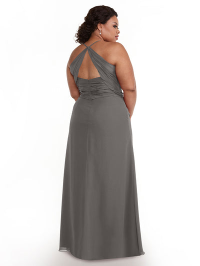 A woman in Avery Austin's 80167, a long gray chiffon dress with a sweetheart neckline and keyhole back, stands facing away and glances over her shoulder against a plain white background.