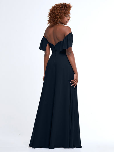 A woman with curly hair models Avery Austin's 80168, an off-the-shoulder, floor-length A-line dress with pockets, as she stands with her back to the camera against a plain white background.