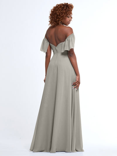 A woman stands facing away on a white background, wearing Avery Austin’s 80168—a light gray, off-the-shoulder, floor-length A-line gown with ruffled sleeves, fitted bodice, and flared skirt.