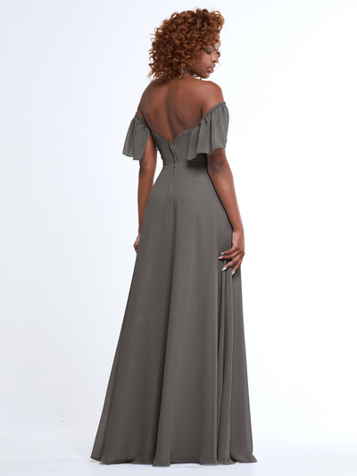 A woman with curly hair, seen from behind against a white background, models Avery Austin’s 80168: an off-the-shoulder, floor-length gray chiffon A-Line dress with pockets.