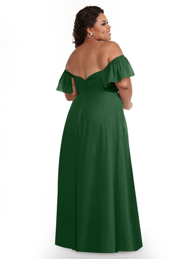 A woman stands facing away, looking over her shoulder, wearing Avery Austin’s dark green chiffon off-the-shoulder A-line floor-length dress (Style 80168), with curled hair and earrings against a white background.